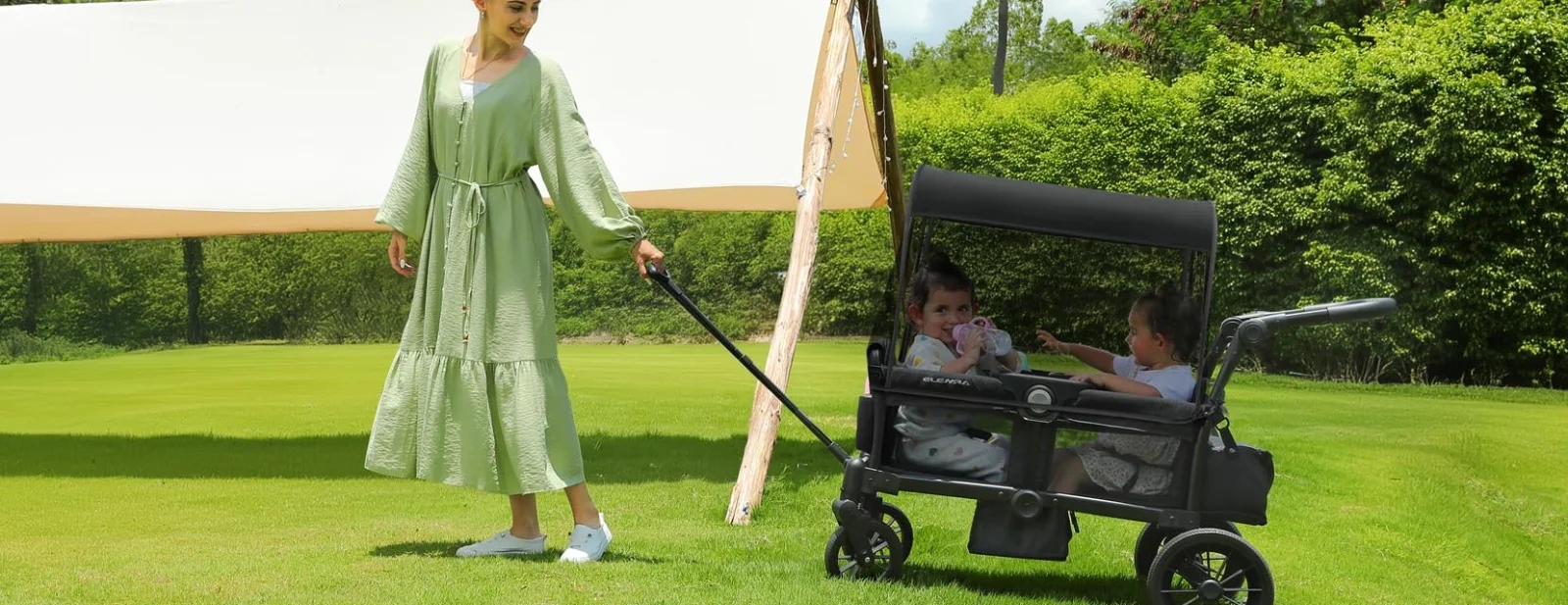 The two-seat wagon on grass, pulled rather than pushed